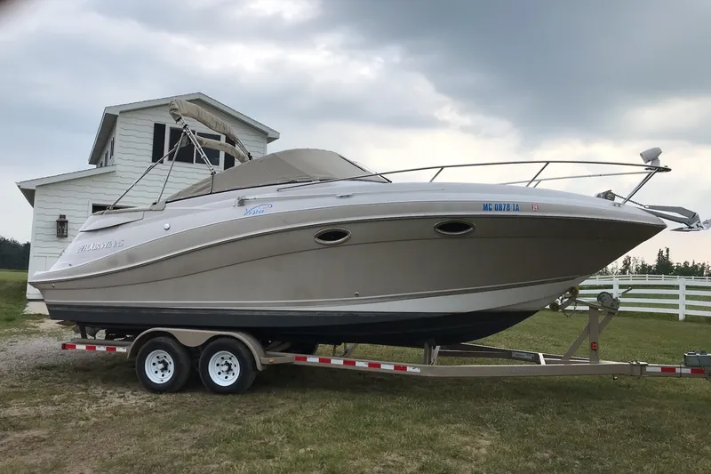 The Image of 2007 Four Winns 288 Vista boat on trailer, parked near a white house. - 0