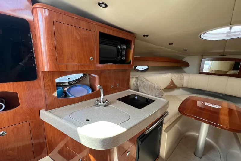 Slide: The Image of Luxurious interior of 2007 Four Winns 288 Vista yacht with kitchenette and seating area. - 16