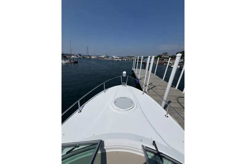 Slide: The Image of 2007 Four Winns 288 Vista boat docked at a marina under clear blue skies. - 12