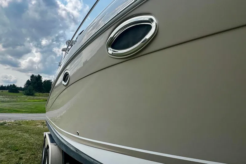 Slide: The Image of 2007 Four Winns 288 Vista boat side view with cloudy sky background. - 10