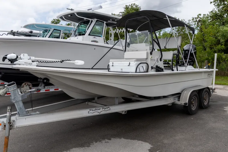 Slide: The Image of 2020 Shallow Sport 21 Sport boat on trailer, parked outdoors. - 16