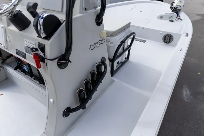 Slide: The Image of 2020 Shallow Sport 21 Sport boat interior with steering console and rod holders. - 13
