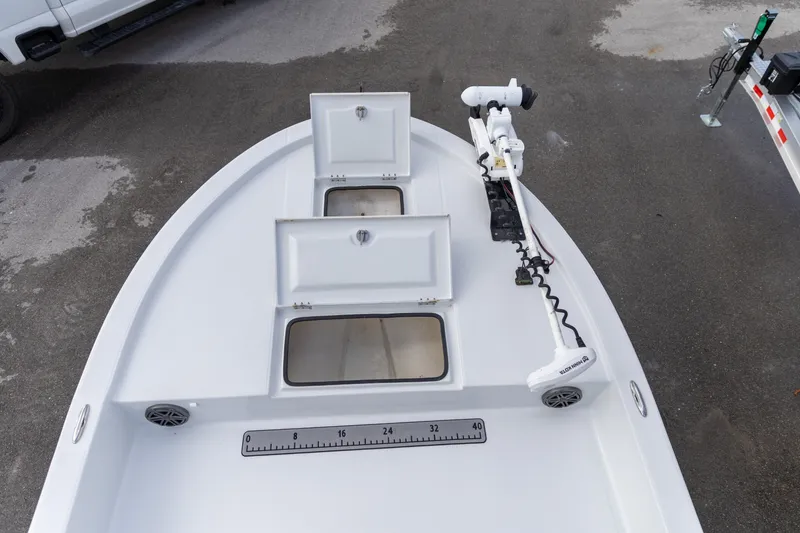 Slide: The Image of 2020 Shallow Sport 21 Sport boat deck with storage compartments and trolling motor. - 14