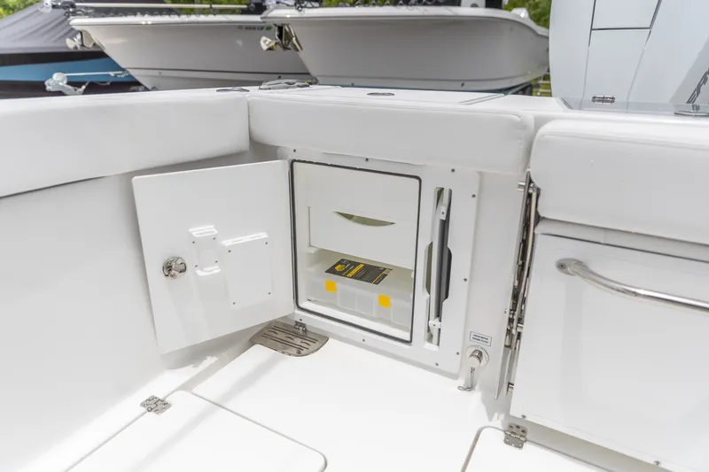 Slide: The Image of 2026 Crevalle 33 CSF boat storage compartment with open door, showcasing interior space. - 14