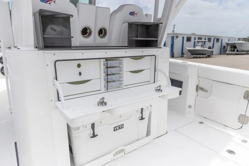 Slide: The Image of 2026 Crevalle 33 CSF boat interior with storage compartments and Yeti cooler. - 6