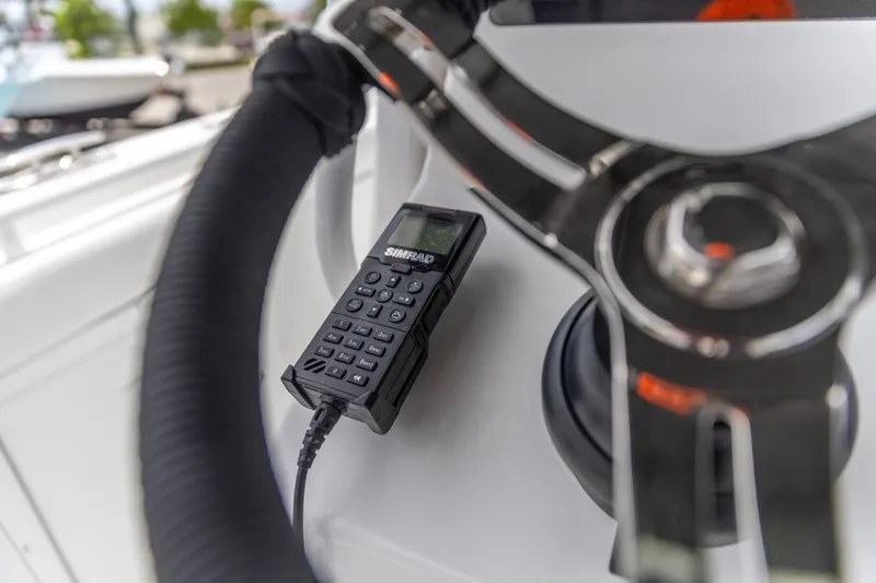 Slide: The Image of Simrad marine radio on 2026 Crevalle 33 CSF boat dashboard, close-up view. - 28