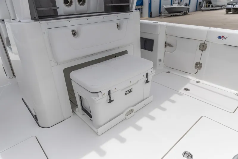 Slide: The Image of 2026 Crevalle 33 CSF boat interior with Yeti cooler and storage compartments. - 19