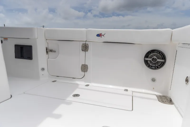 Slide: The Image of 2026 Crevalle 33 CSF boat interior with storage compartments and speaker system. - 22