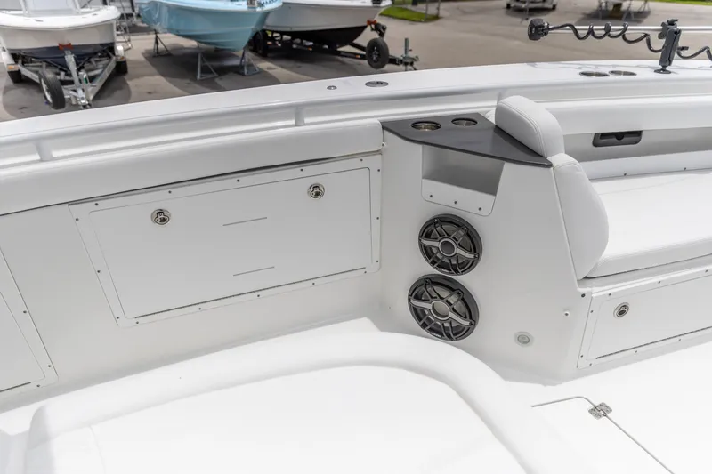 Slide: The Image of 2026 Crevalle 33 CSF boat interior with seating, speakers, and storage compartments. - 31