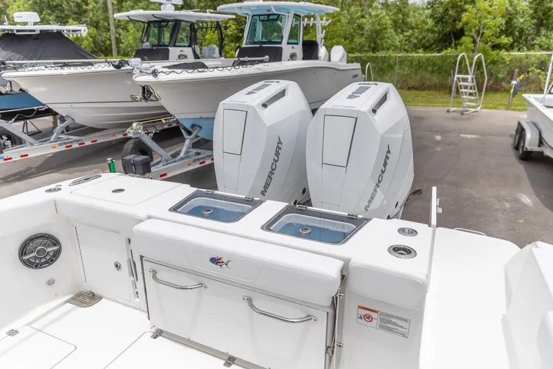 Slide: The Image of 2026 Crevalle 33 CSF boat with dual Mercury outboard engines, docked with other boats. - 7
