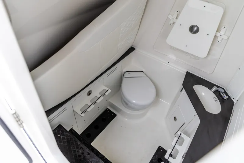 Slide: The Image of 2026 Crevalle 33 CSF boat interior bathroom with toilet and sink. - 4