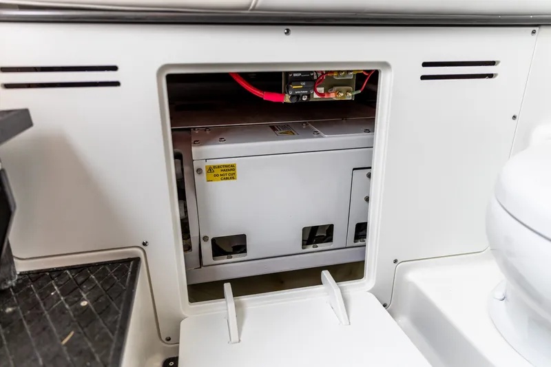 Slide: The Image of Electrical compartment in 2026 Crevalle 33 CSF boat, featuring safety warning labels. - 40
