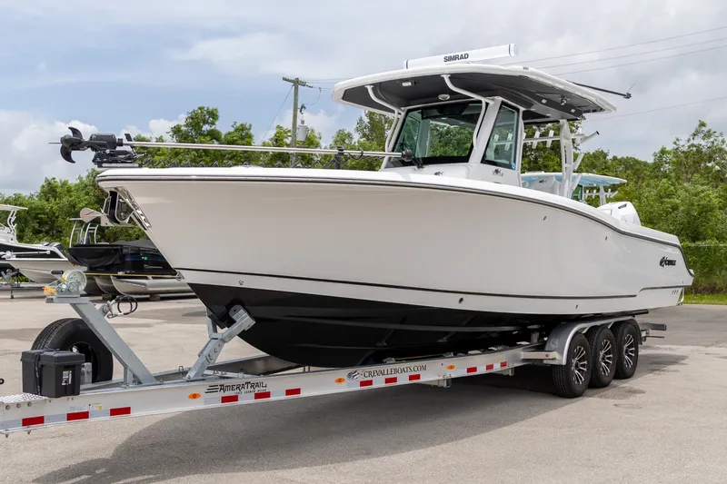Slide: The Image of 2026 Crevalle 33 CSF boat on trailer, parked outdoors, showcasing sleek design. - 46