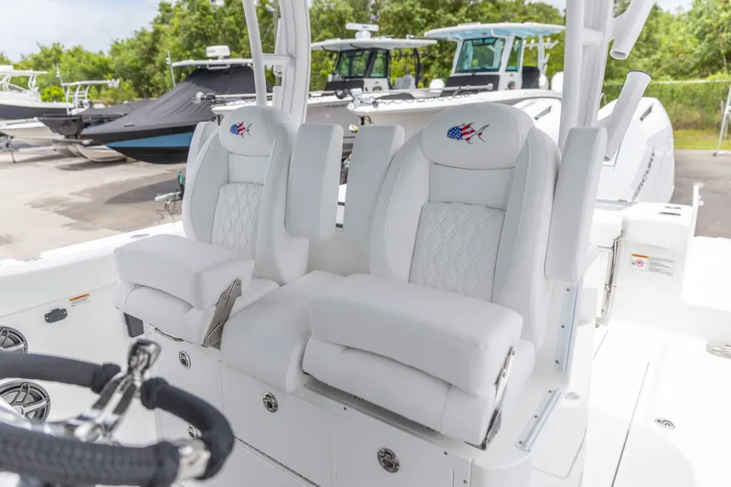 Slide: The Image of Luxury seating on 2026 Crevalle 33 CSF boat, featuring white cushioned captain's chairs. - 3
