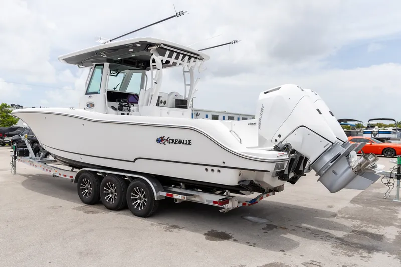 Slide: The Image of 2026 Crevalle 33 CSF boat on trailer, featuring dual outboard engines. - 13