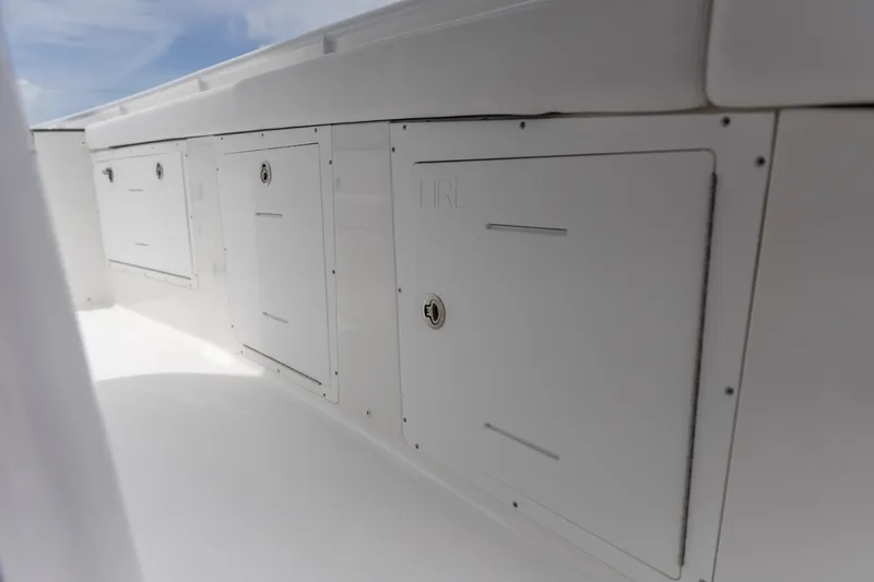 Slide: The Image of Storage compartments on a 2026 Crevalle 33 CSF boat, featuring sleek white design. - 29