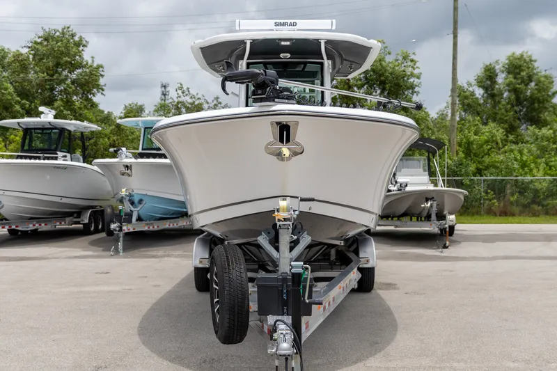 Slide: The Image of 2026 Crevalle 33 CSF boat on trailer, surrounded by trees and other boats. - 45