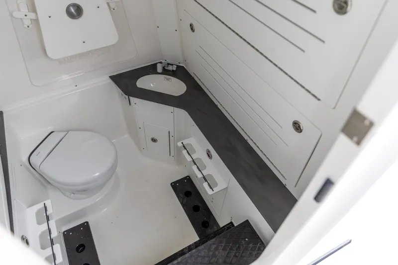 Slide: The Image of 2026 Crevalle 33 CSF boat interior with toilet and sink, featuring modern design. - 36