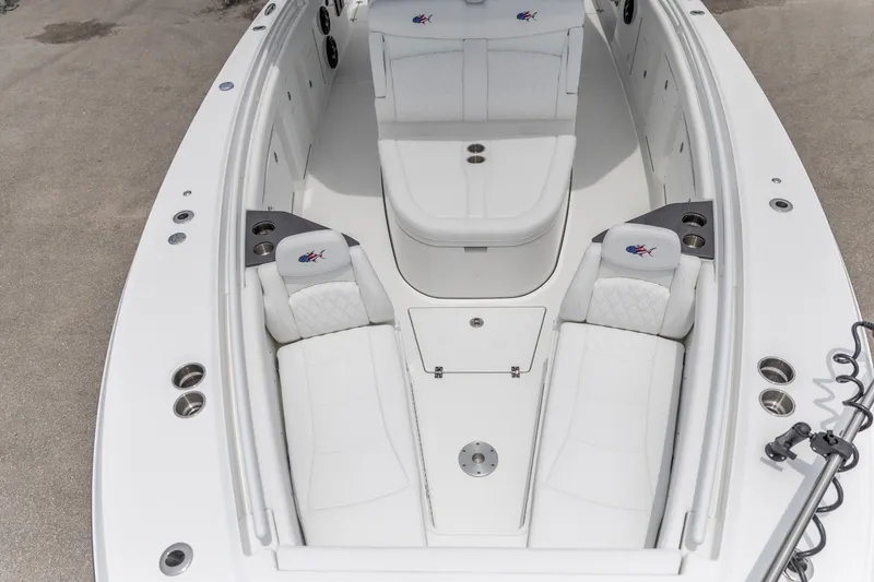 Slide: The Image of 2026 Crevalle 33 CSF boat interior with white seating and cup holders. - 21