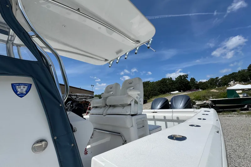 Slide: The Image of 2013 Southport 27 FE boat with dual engines and seating, under a clear blue sky. - 38