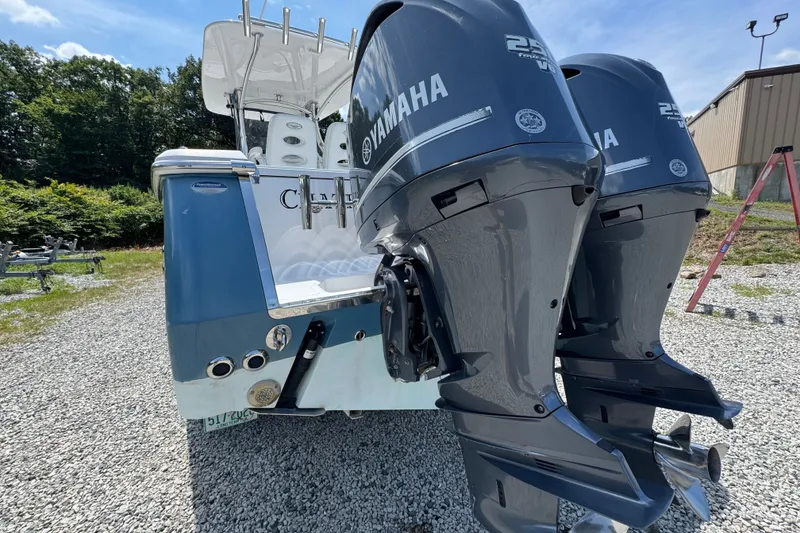 Slide: The Image of 2013 Southport 27 FE boat with dual Yamaha outboard motors on gravel. - 13