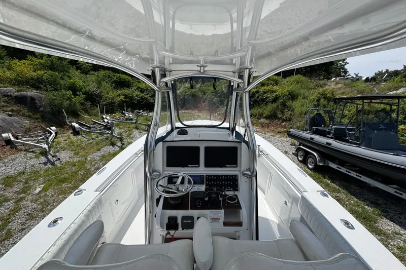 Slide: The Image of 2013 Southport 27 FE boat cockpit with steering wheel and control panel. - 19