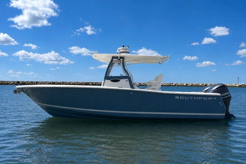Slide: The Image of 2013 Southport 27 FE boat on calm water under a clear blue sky. - 2