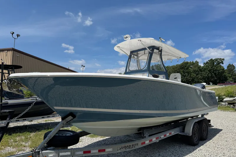 Slide: The Image of 2013 Southport 27 FE boat on trailer under clear blue sky. - 4