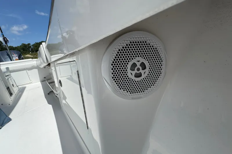Slide: The Image of 2013 Southport 27 FE boat interior with speaker and storage compartments. - 35