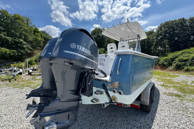 Slide: The Image of 2013 Southport 27 FE boat with dual Yamaha engines on a gravel lot. - 12