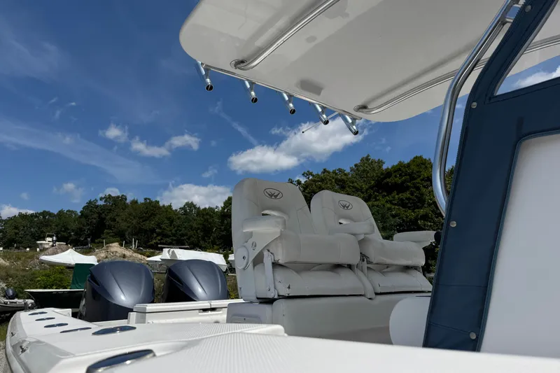 Slide: The Image of 2013 Southport 27 FE boat with dual engines and comfortable seating under a clear blue sky. - 22