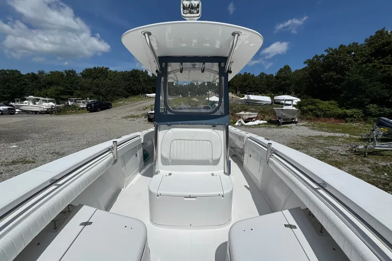Slide: The Image of 2013 Southport 27 FE boat with seating, parked outdoors under a clear blue sky. - 42