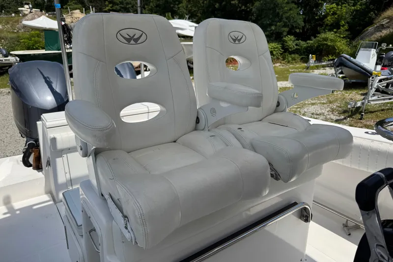 Slide: The Image of Luxury seating on a 2013 Southport 27 FE boat, featuring plush white captain's chairs. - 32