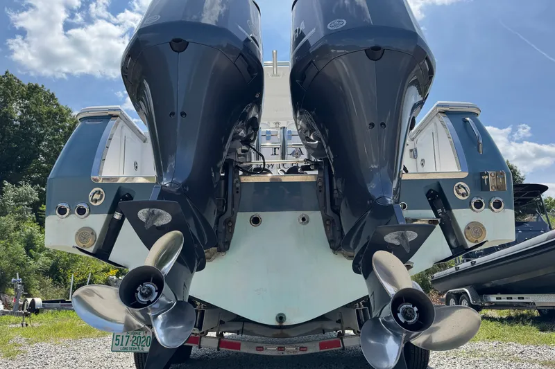 Slide: The Image of Rear view of a 2013 Southport 27 FE boat with dual outboard motors. - 14