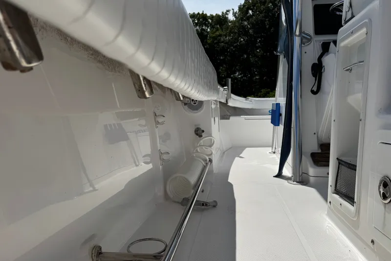 Slide: The Image of Interior view of a 2013 Southport 27 FE boat, showcasing sleek white deck and fittings. - 34