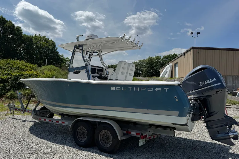 Slide: The Image of 2013 Southport 27 FE boat on trailer with Yamaha engine, parked outdoors. - 10