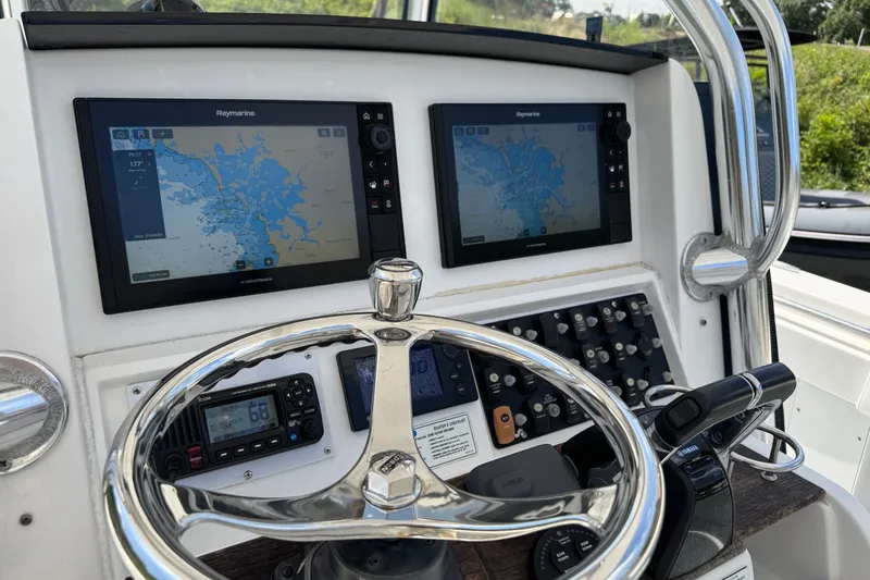 Slide: The Image of Control panel of a 2013 Southport 27 FE boat with navigation screens. - 16