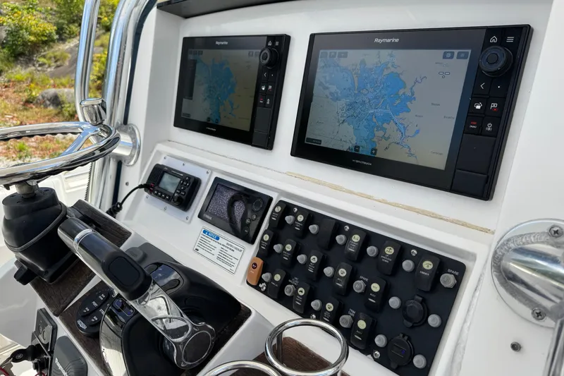 Slide: The Image of Control panel of a 2013 Southport 27 FE boat with navigation screens and controls. - 21