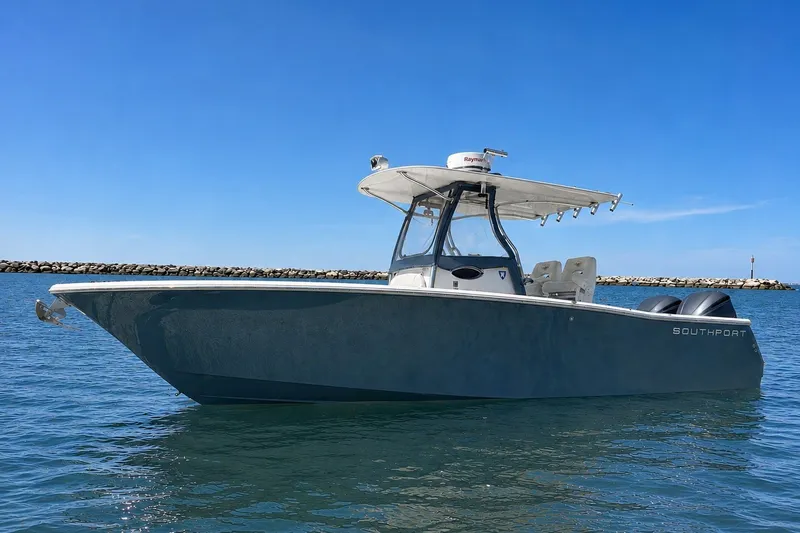 Slide: The Image of 2013 Southport 27 FE boat on calm water under clear blue sky. - 1