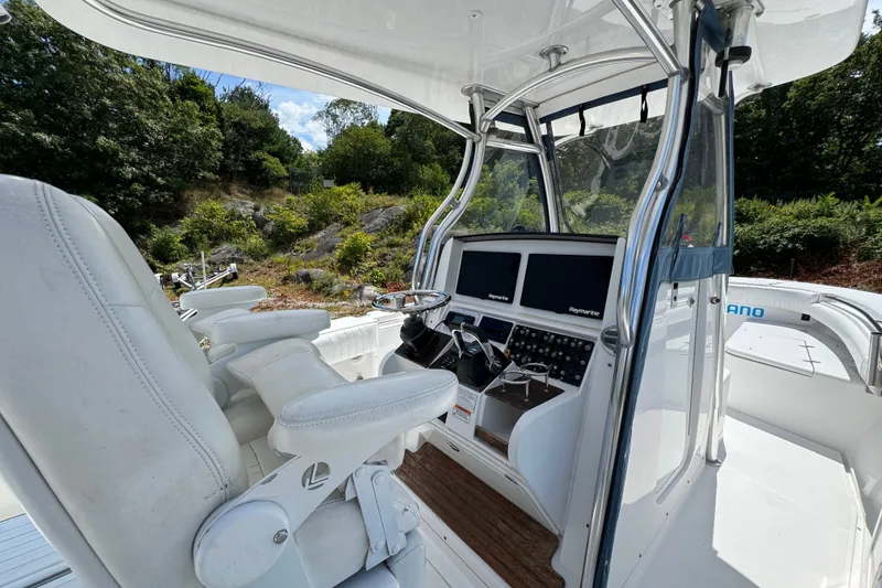 Slide: The Image of 2013 Southport 27 FE boat cockpit with dual screens and white seating. - 17