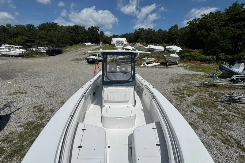 Slide: The Image of 2013 Southport 27 FE boat on gravel lot under blue sky. - 43