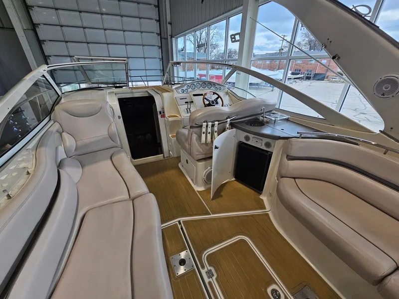 Slide: The Image of The image shows the cockpit of a 2001 Doral 330se with beige seating and a helm station. - 2