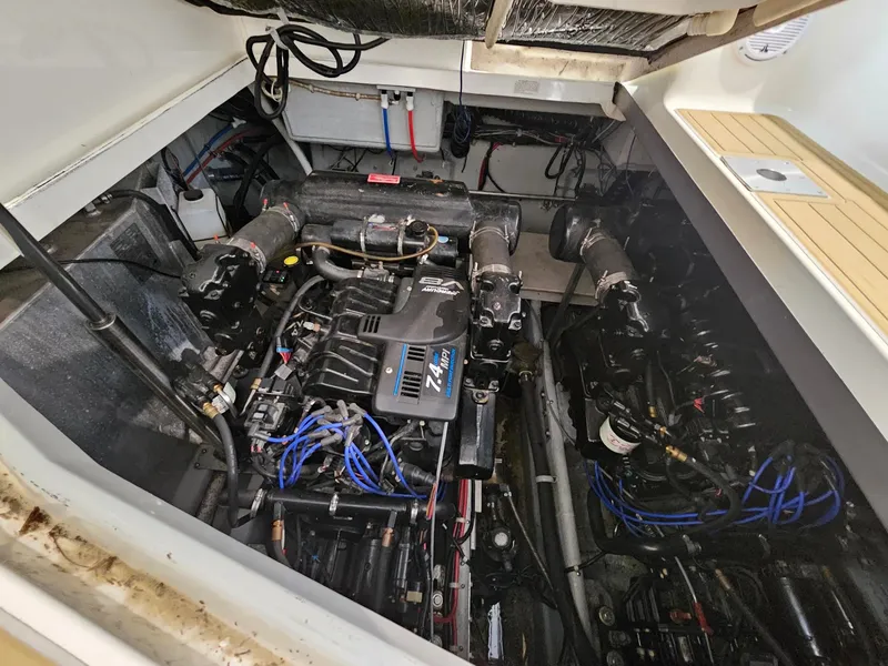 Slide: The Image of The engine compartment of a 2001 Doral 330se shows two engines with blue wires and hoses. - 12