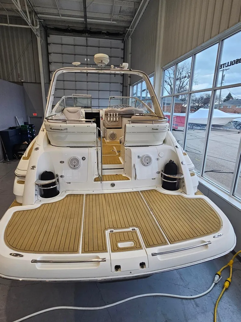 Slide: The Image of The image shows the stern of a 2001 Doral 330se boat with a teak deck. - 6