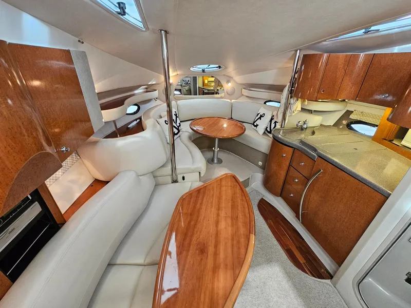Slide: The Image of The interior cabin of a 2001 Doral 330se features elegant wood furnishings and white upholstery. - 8