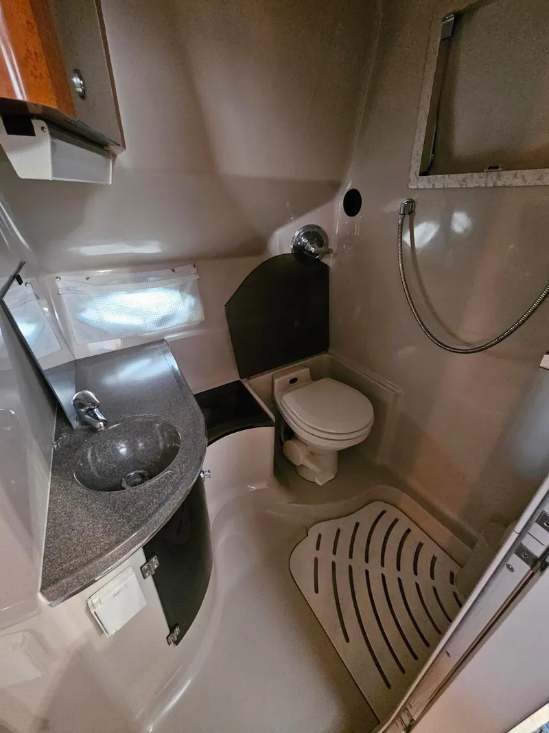 Slide: The Image of The image shows a boat bathroom with a sink, toilet, and shower. - 10