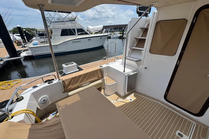 Slide: The Image of 2020 Ranger Tugs R-31 CB boat deck with seating, docked at marina. - 7