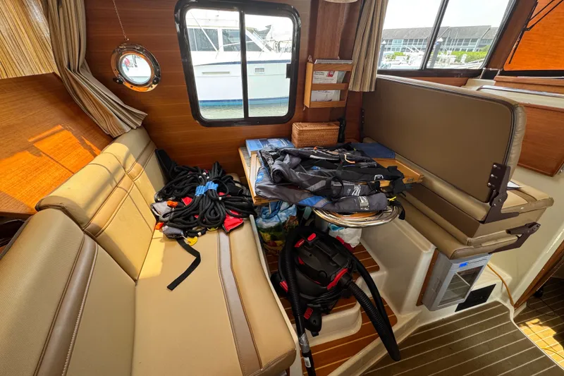 Slide: The Image of Interior of 2020 Ranger Tugs R-31 CB with seating and nautical gear. - 16