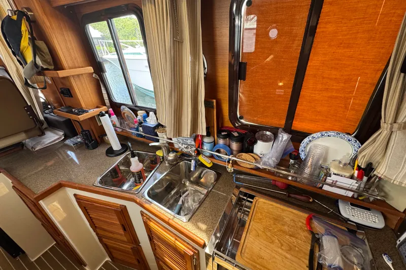 Slide: The Image of 2020 Ranger Tugs R-31 CB galley with sink, countertop, and kitchen essentials. - 20