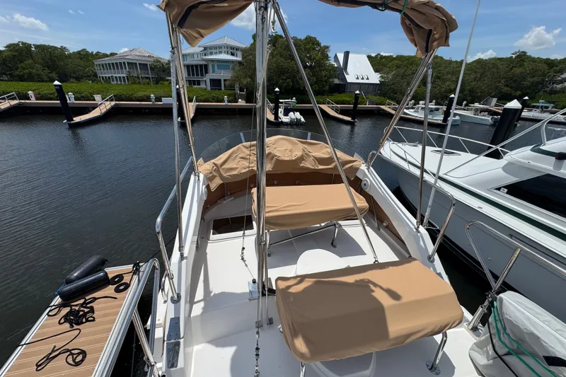 Slide: The Image of 2020 Ranger Tugs R-31 CB boat docked at marina with covered seating area. - 13